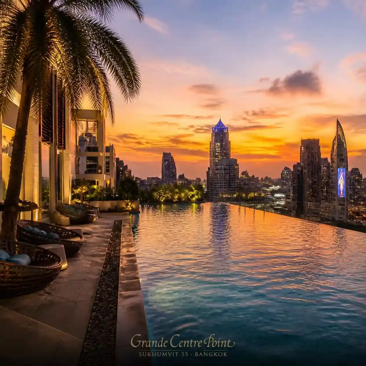 Rooftop Sunset Pool at Grande Centre Point Sukhumvit 55 overlooking the Bangkok skyline at dusk in Thonglor