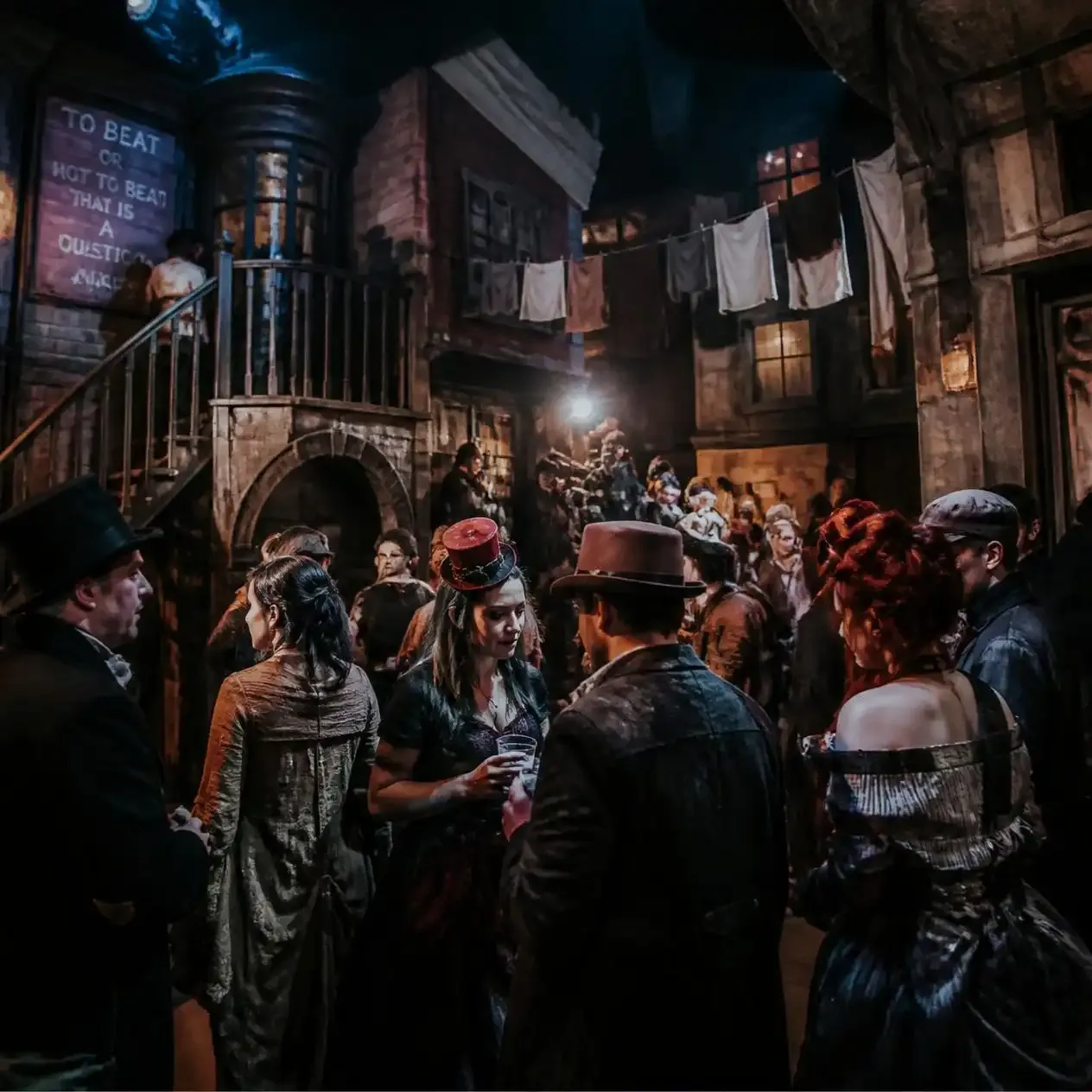 Audience in costume exploring a themed built set at a Secret Cinema London immersive production