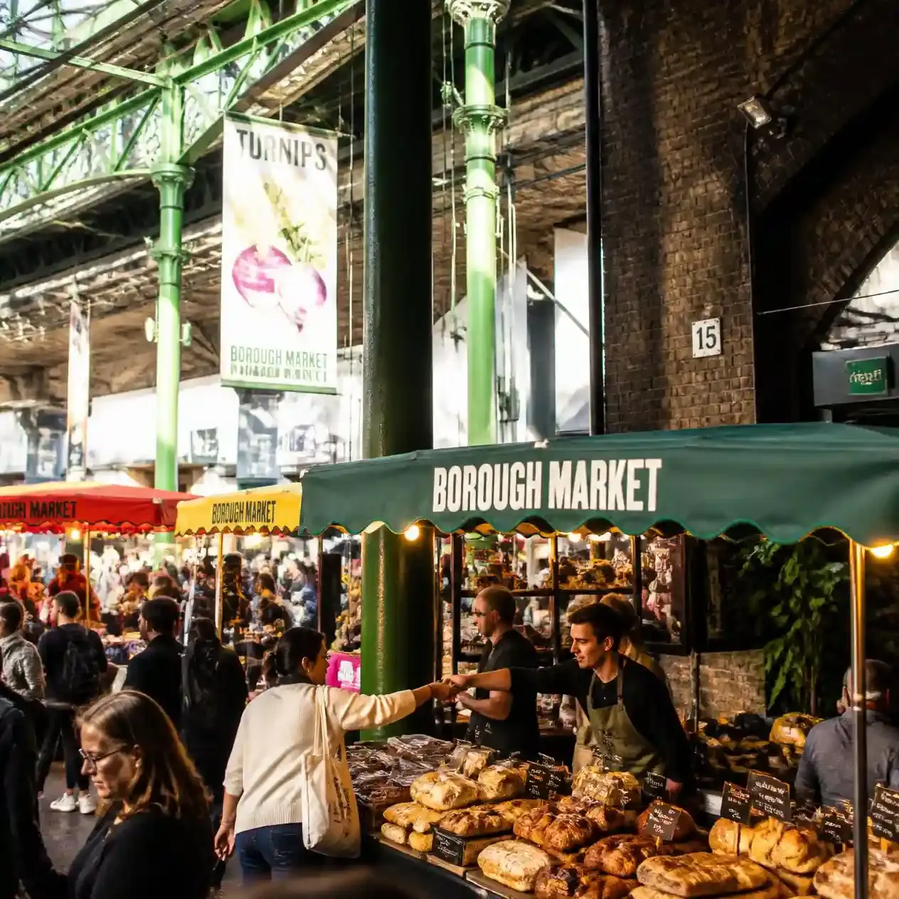 Produce stalls trading beneath Victorian ironwork and railway arches at Borough Market in Southwark, London