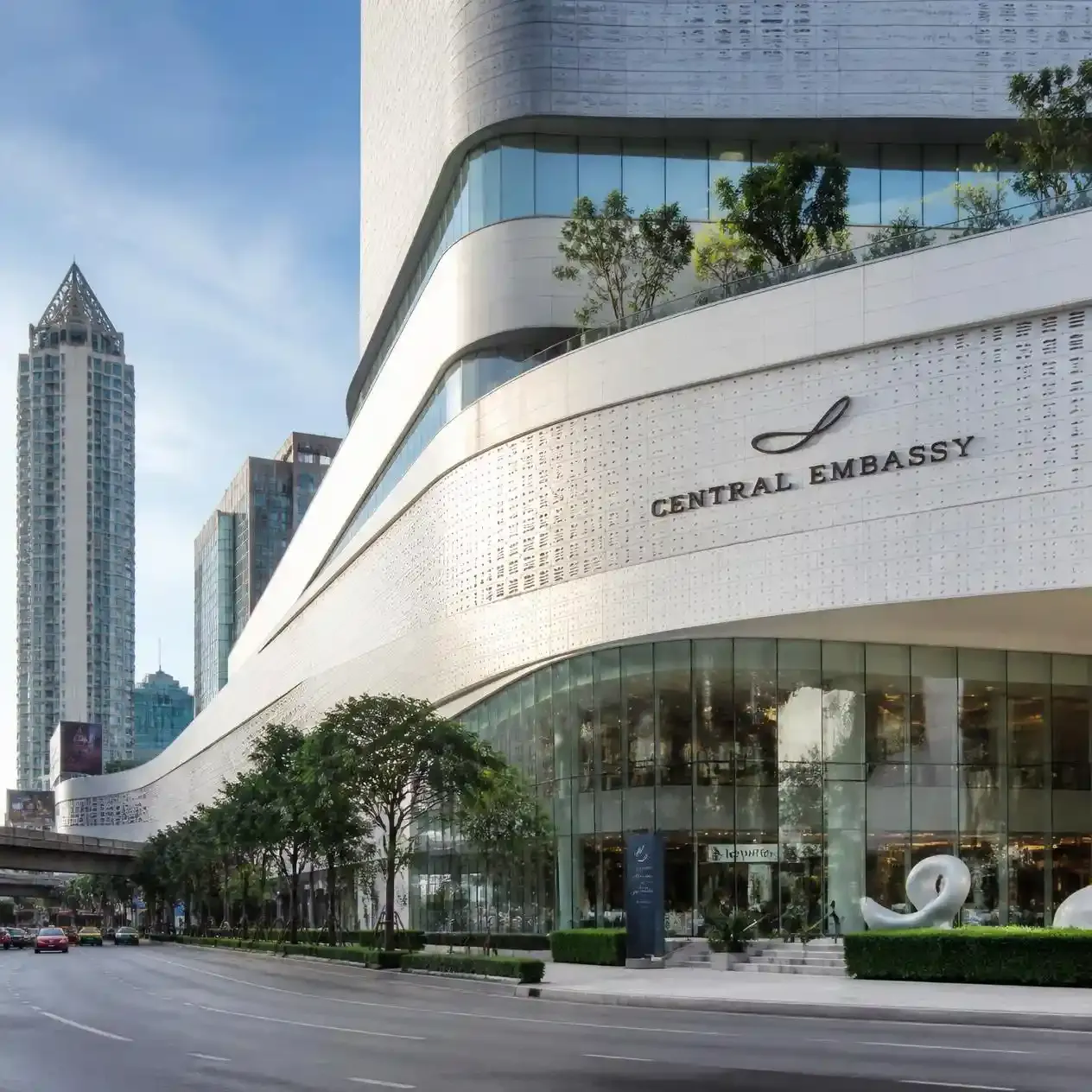 The curved perforated white facade of Central Embassy on Phloen Chit Road, one of the luxury shopping malls in Bangkok