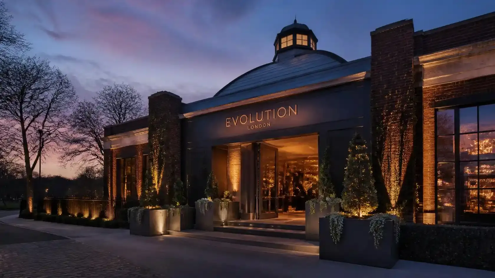 Evolution London venue in Battersea Park lit at dusk, home of the Secret Cinema Grease production
