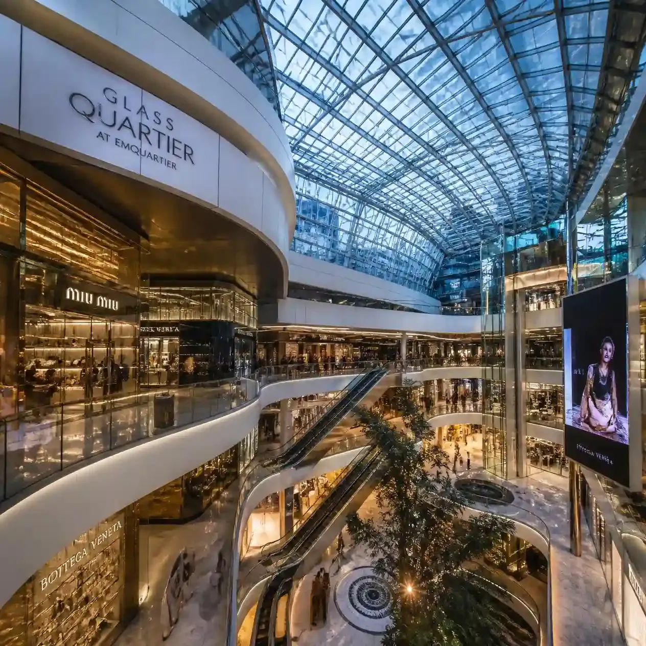 The Glass Quartier atrium at EmQuartier in Bangkok with designer boutiques rising around a central spiral