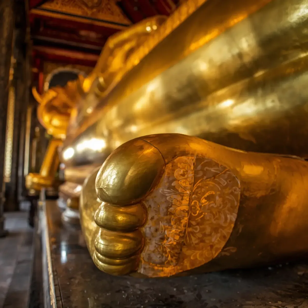 Golden spires and mosaic-covered chedi of Wat Phra Kaew inside the Grand Palace walls in Bangkok