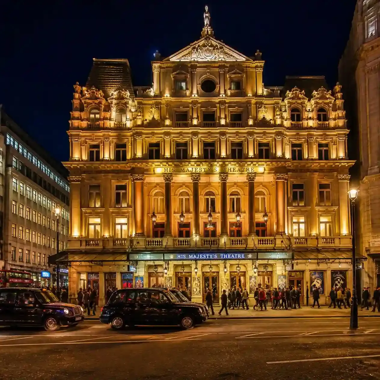 Illuminated facade of His Majesty's Theatre on Haymarket at night, home of The Phantom of the Opera in London