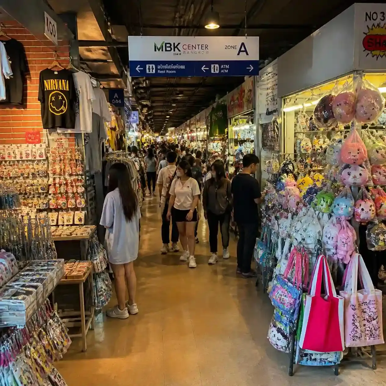 Narrow corridor of independent stalls and shopfronts on an upper floor of MBK Center Bangkok