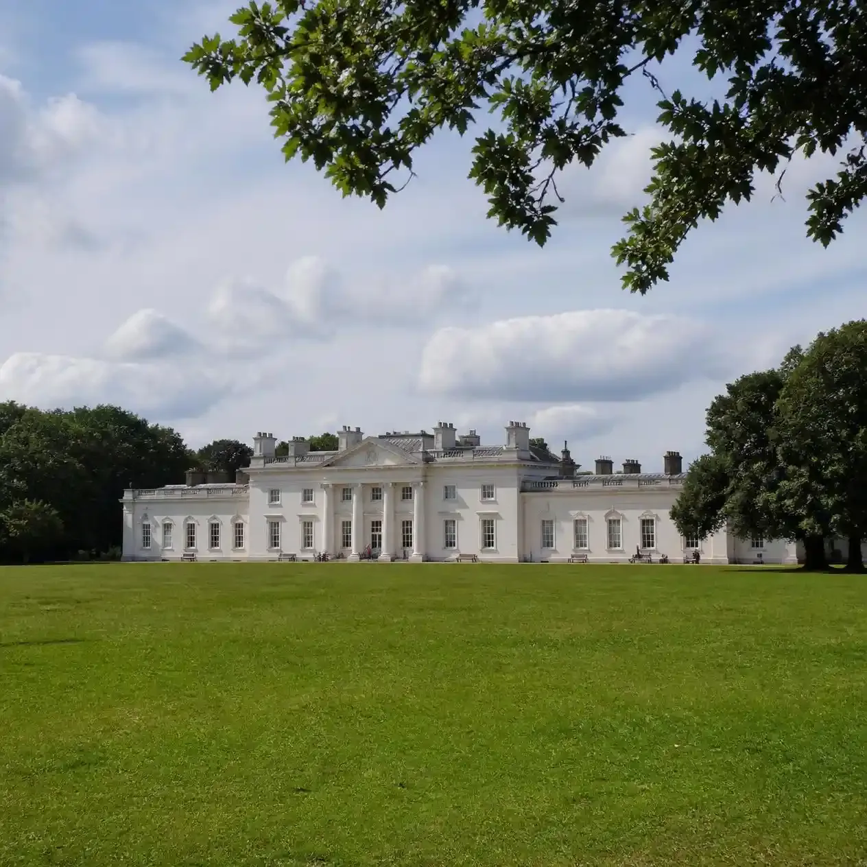 The neoclassical facade of Kenwood House across the lawn on the northern edge of Hampstead Heath