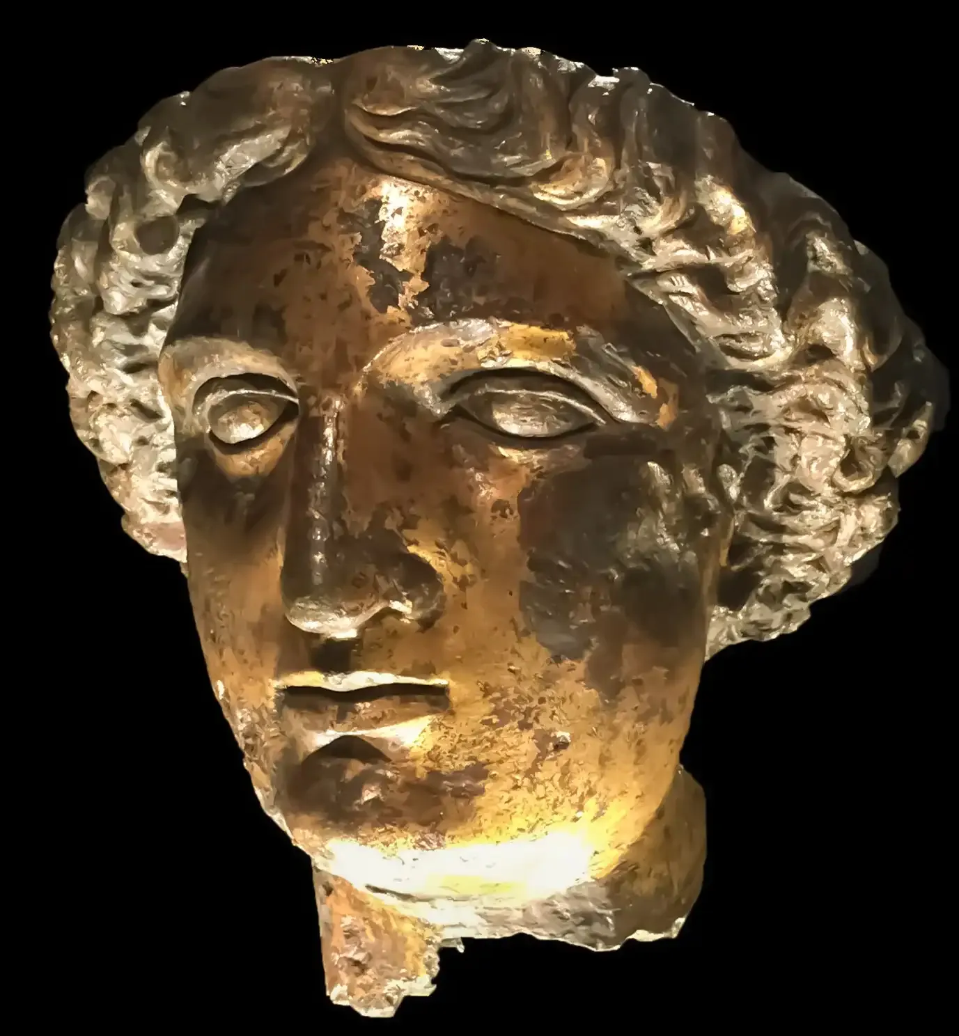 The gilt-bronze head of the goddess Sulis Minerva on display in the Roman Baths museum in Bath