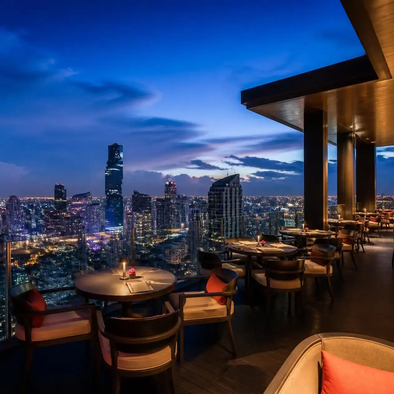 Open-air terrace of Moon Bar on the 61st floor of Banyan Tree Bangkok at dusk overlooking the Sathon skyline