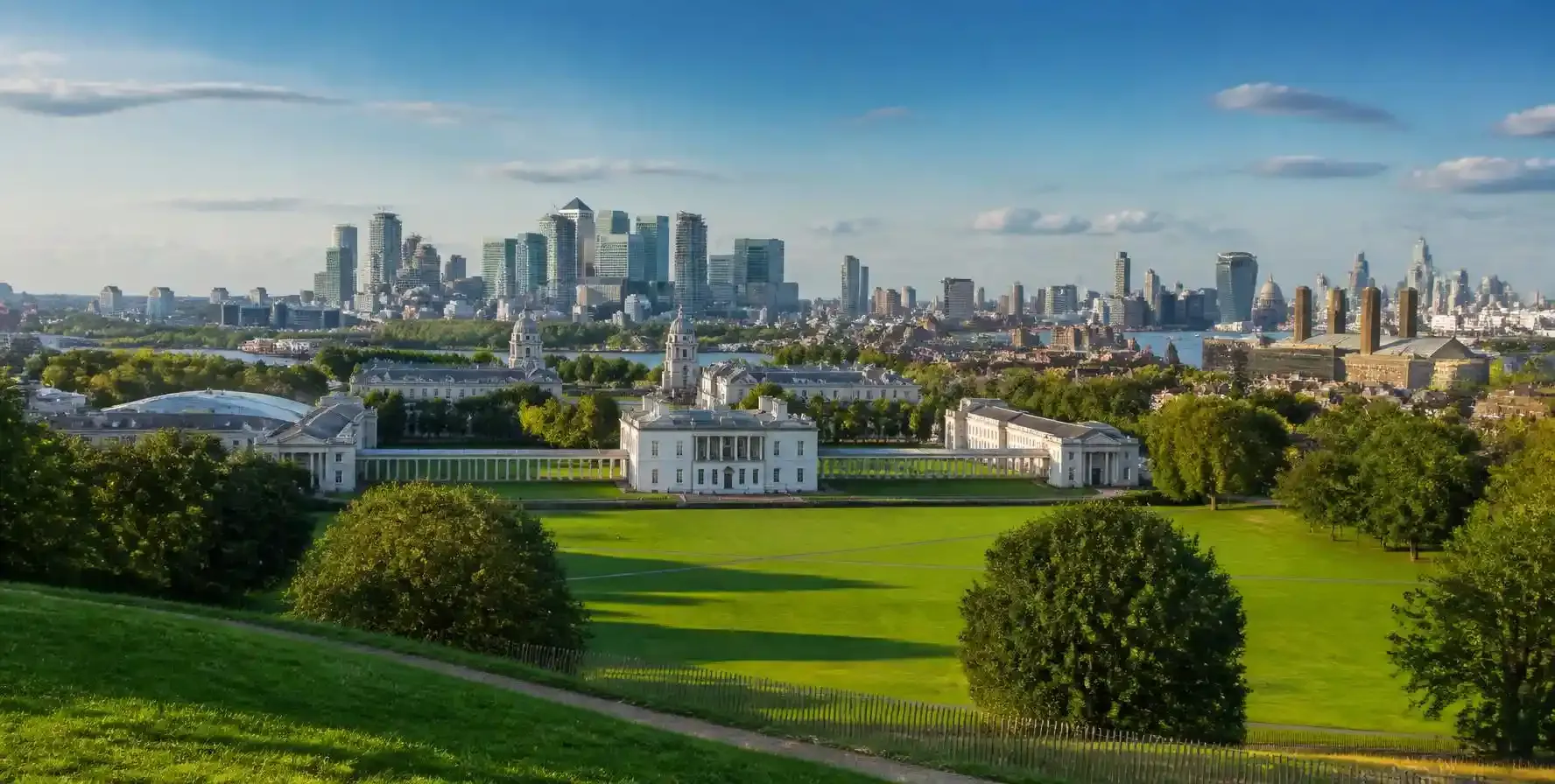 View from Observatory Hill in Greenwich Park across the Queen's House towards Canary Wharf and the City of London skyline