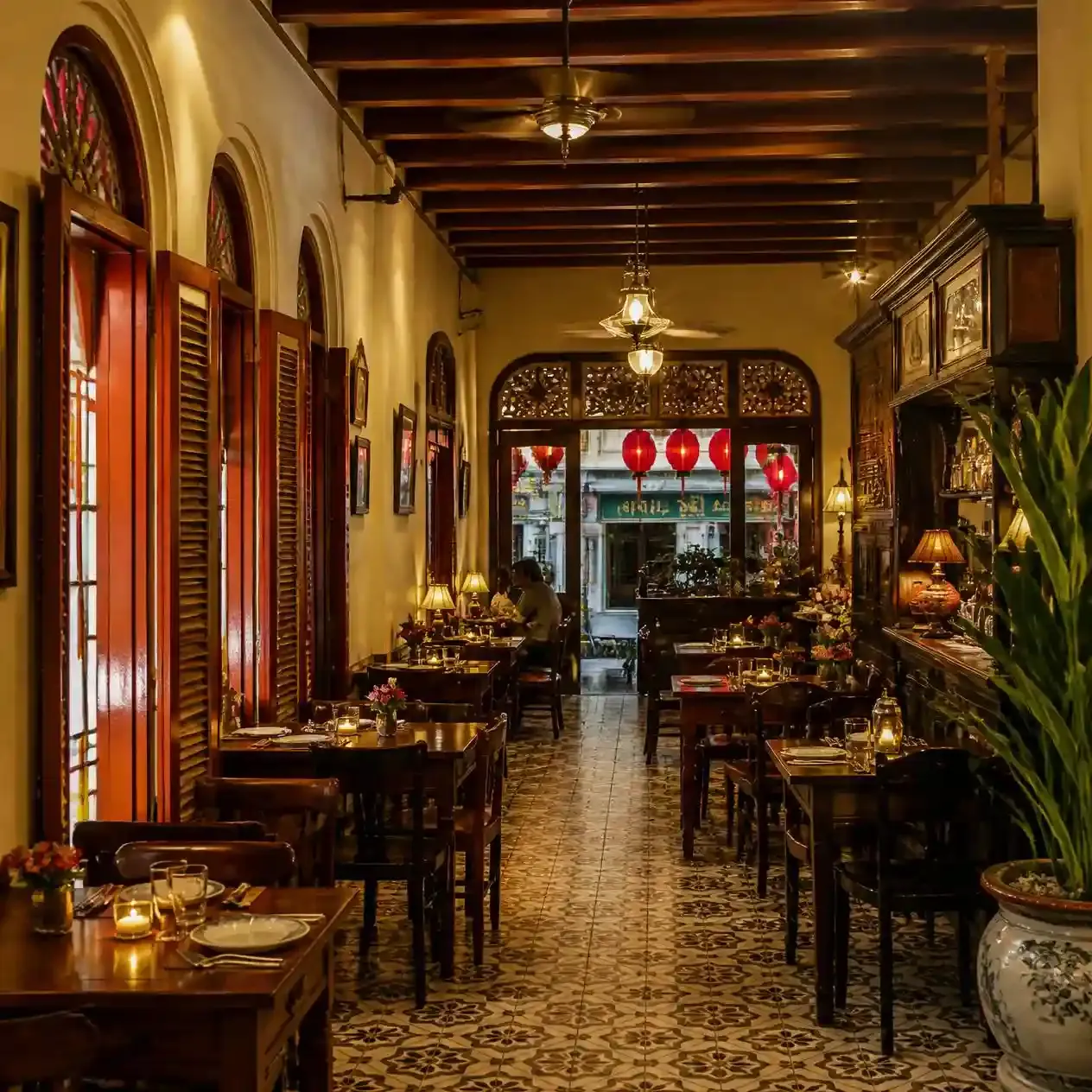 Restored shophouse dining room in the Yaowarat Chinatown district of Bangkok, warmly lit at night