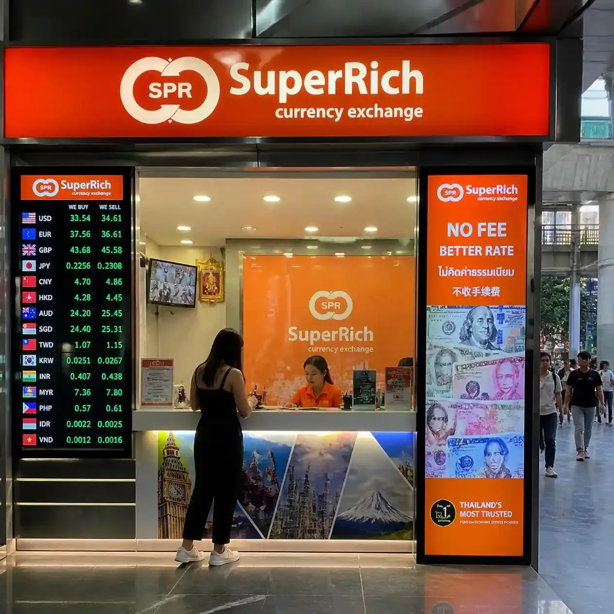 Currency exchange counter on Ratchadamri Road in Bangkok with electronic rate boards showing live rates