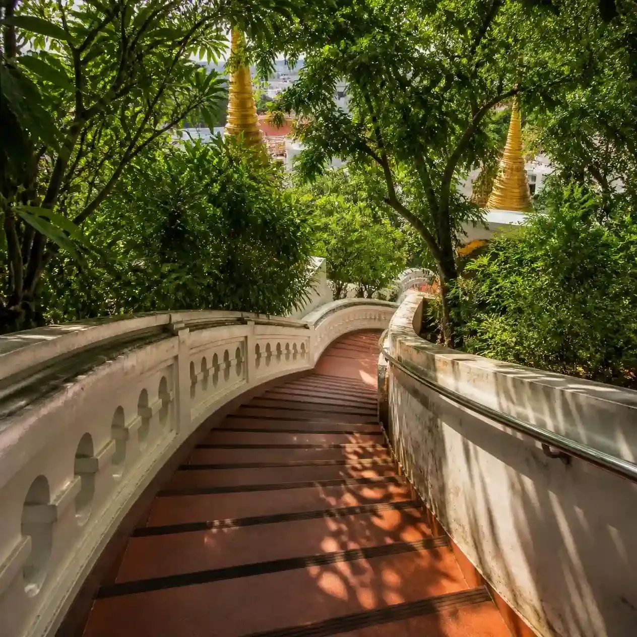 Visitors climbing the 344 gradual steps spiralling around the Golden Mount at Wat Saket in Bangkok