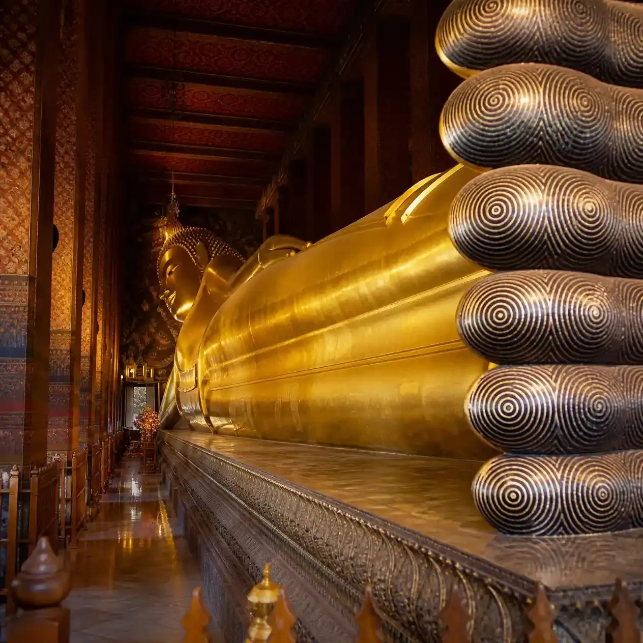 The 46-metre gold-leaf Reclining Buddha stretching the full length of the viharn hall at Wat Pho Bangkok