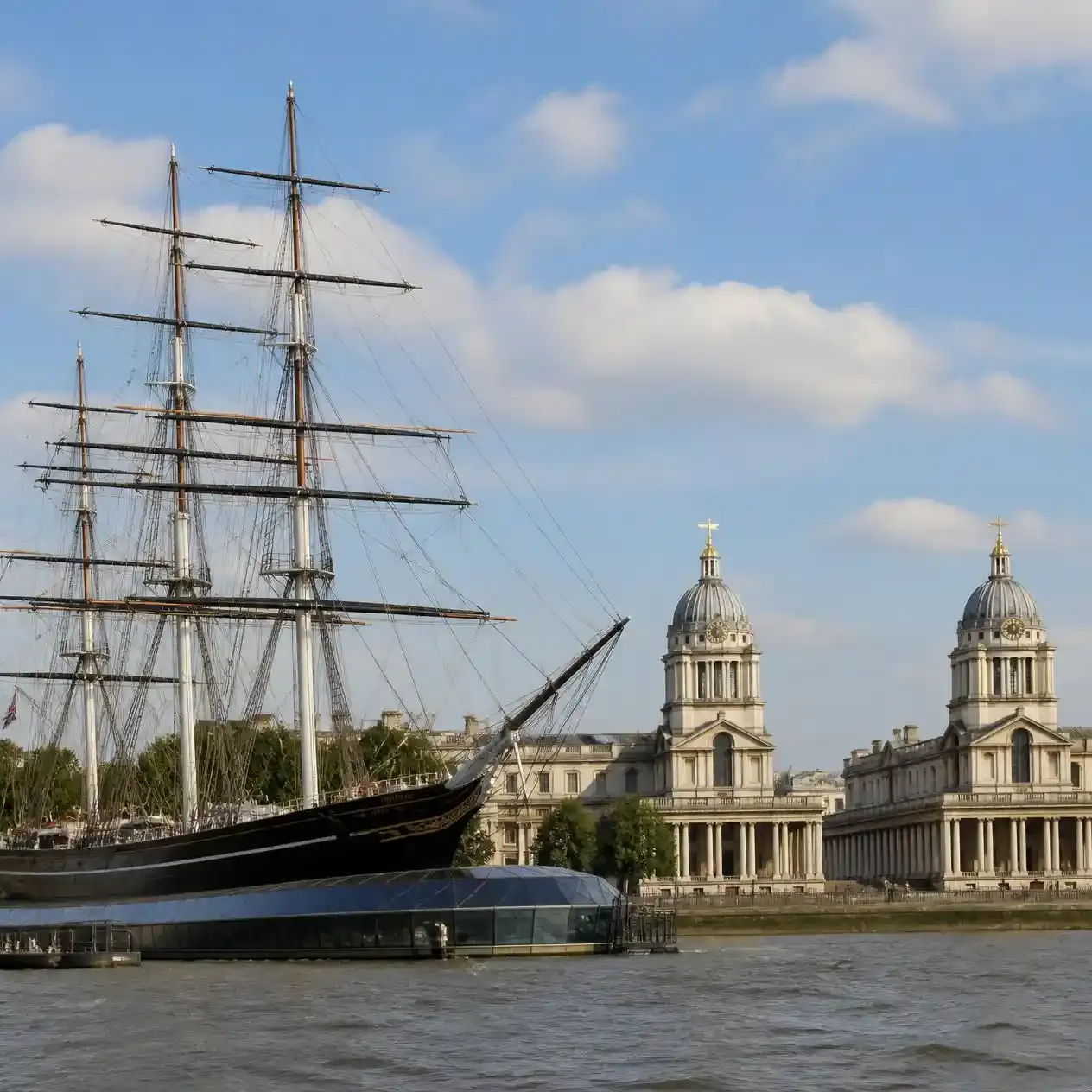 The Cutty Sark and the Old Royal Naval College at the foot of Greenwich Park beside the River Thames in London