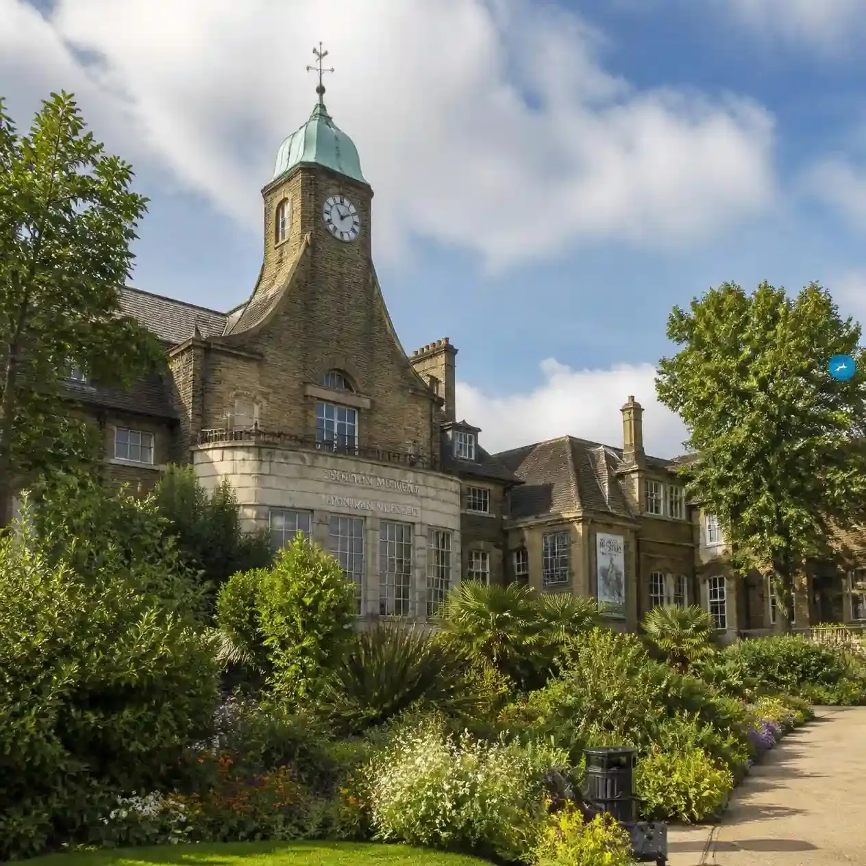 The Horniman Museum's clock tower and Arts and Crafts facade viewed across the gardens in Forest Hill, London