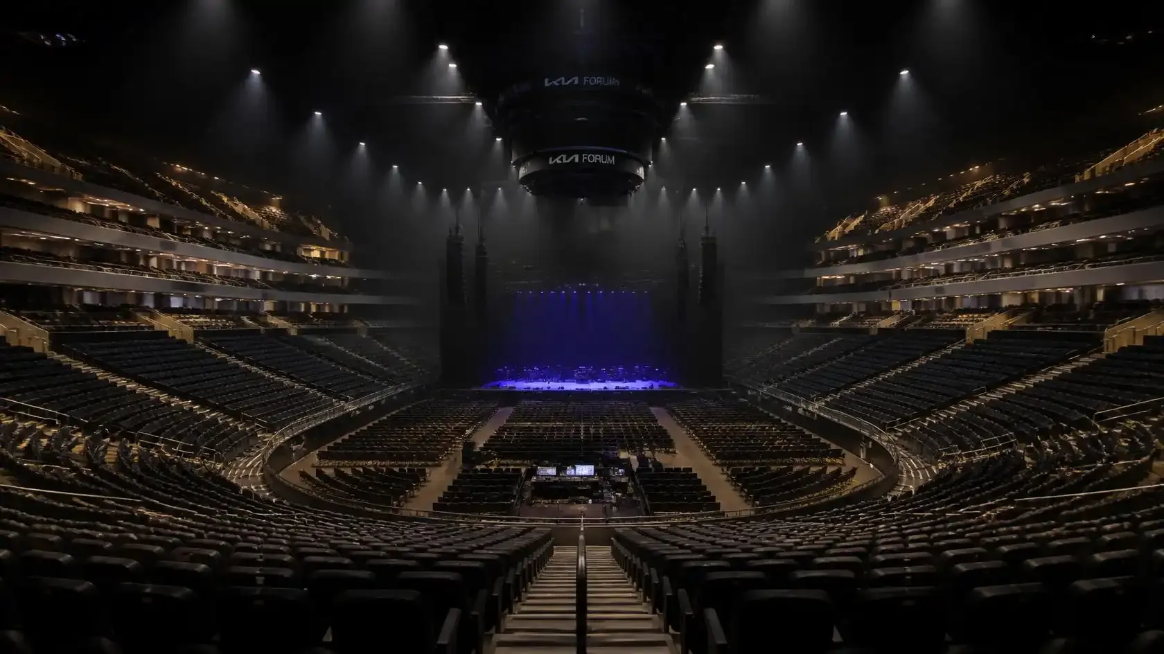 Tiered auditorium seating inside ABBA Arena looking towards the stage before an ABBA Voyage performance
