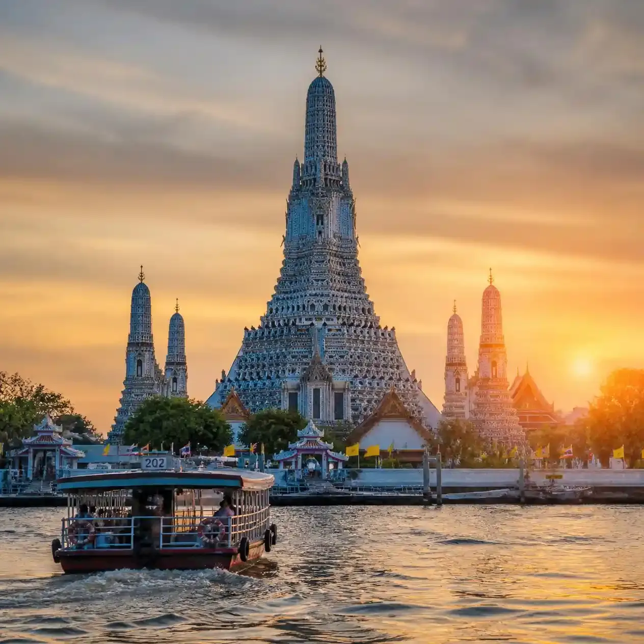 The porcelain-covered prang of Wat Arun viewed from the cross-river ferry on the Chao Phraya in Bangkok
