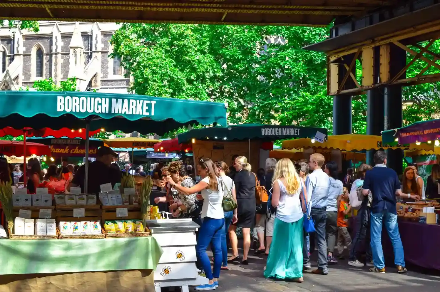 Busy produce and street-food stalls under the railway arches at Borough Market in Southwark near London Bridge