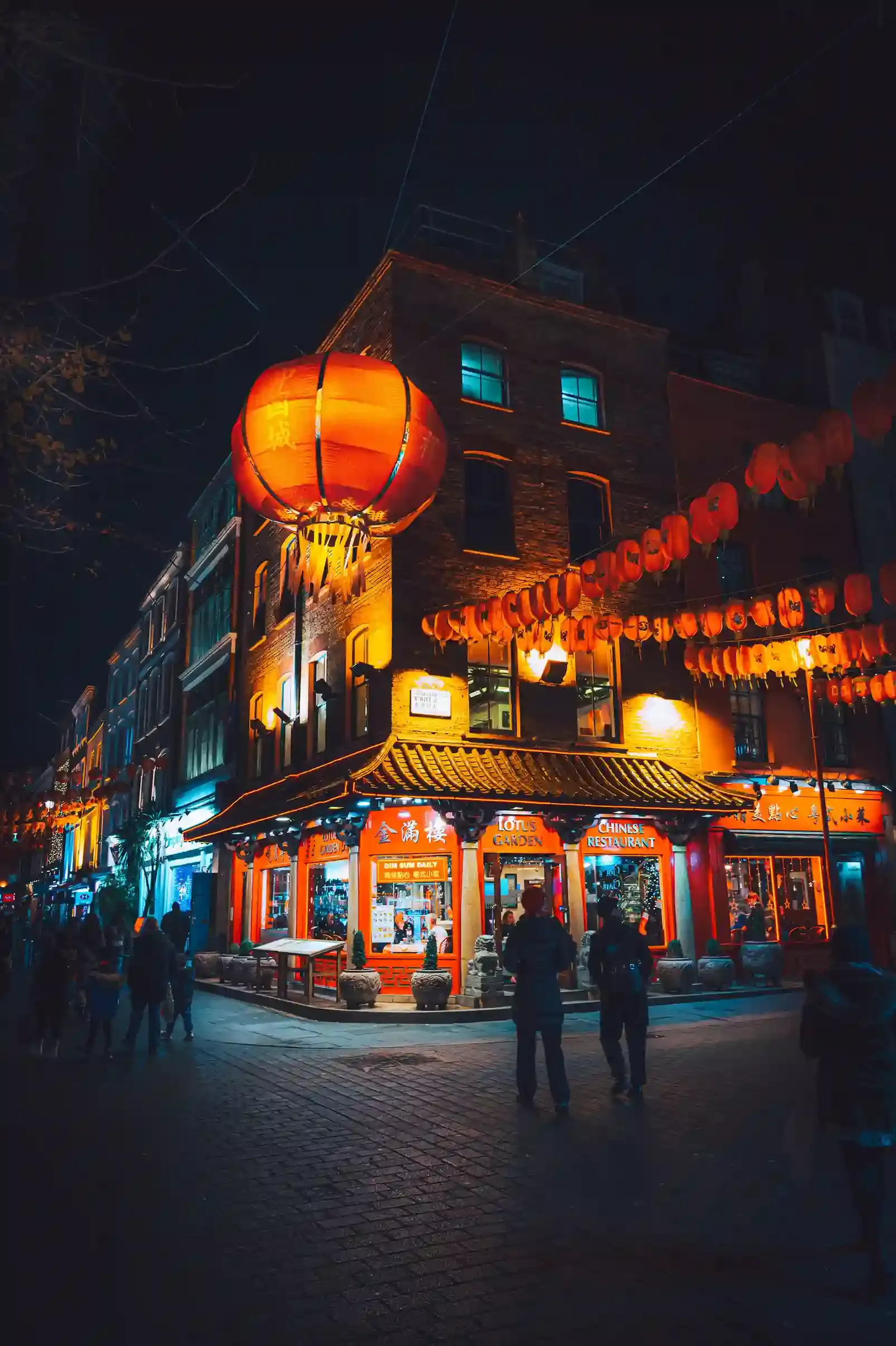 Evening food tour stopping at a lantern-lit restaurant in Chinatown, Soho, London