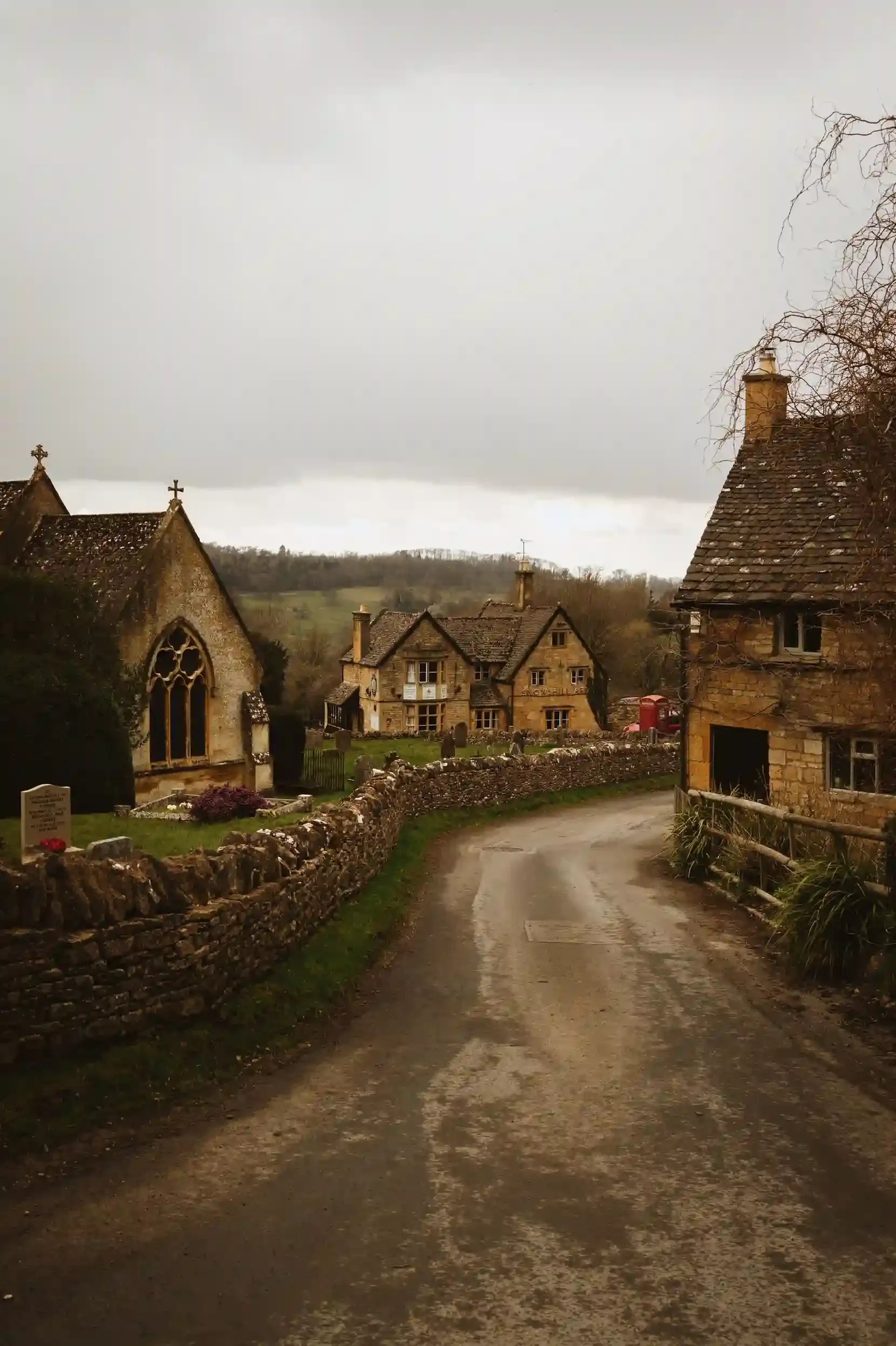 A quiet Cotswolds village lane of honey-coloured stone cottages on a day trip from London
