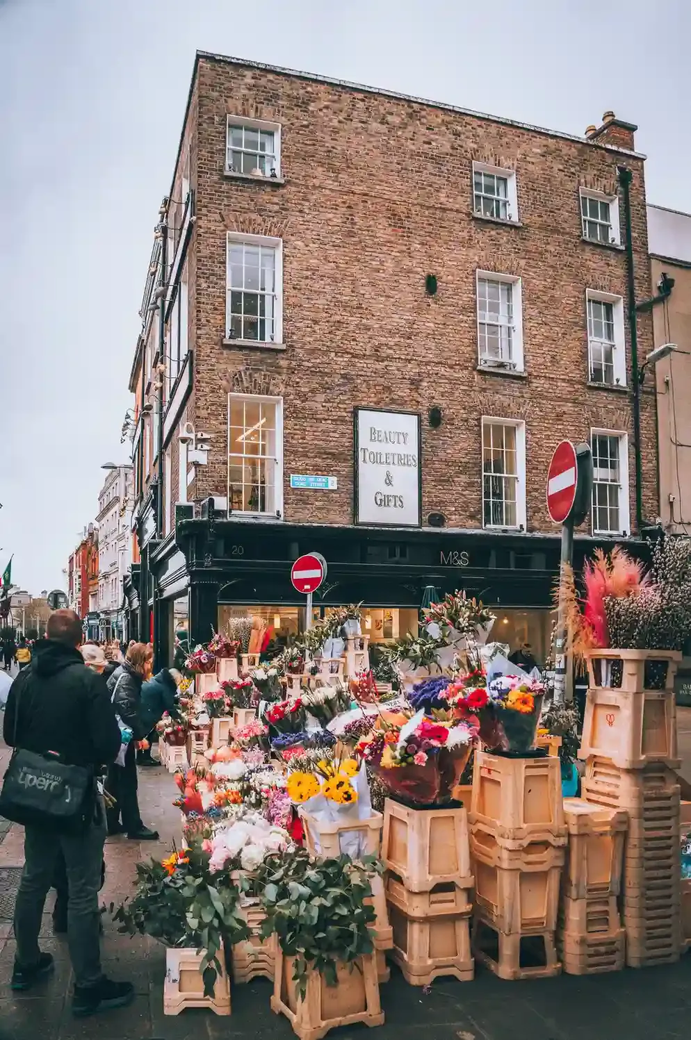 Flower stalls lining Columbia Road Flower Market in East London on a busy Sunday morning