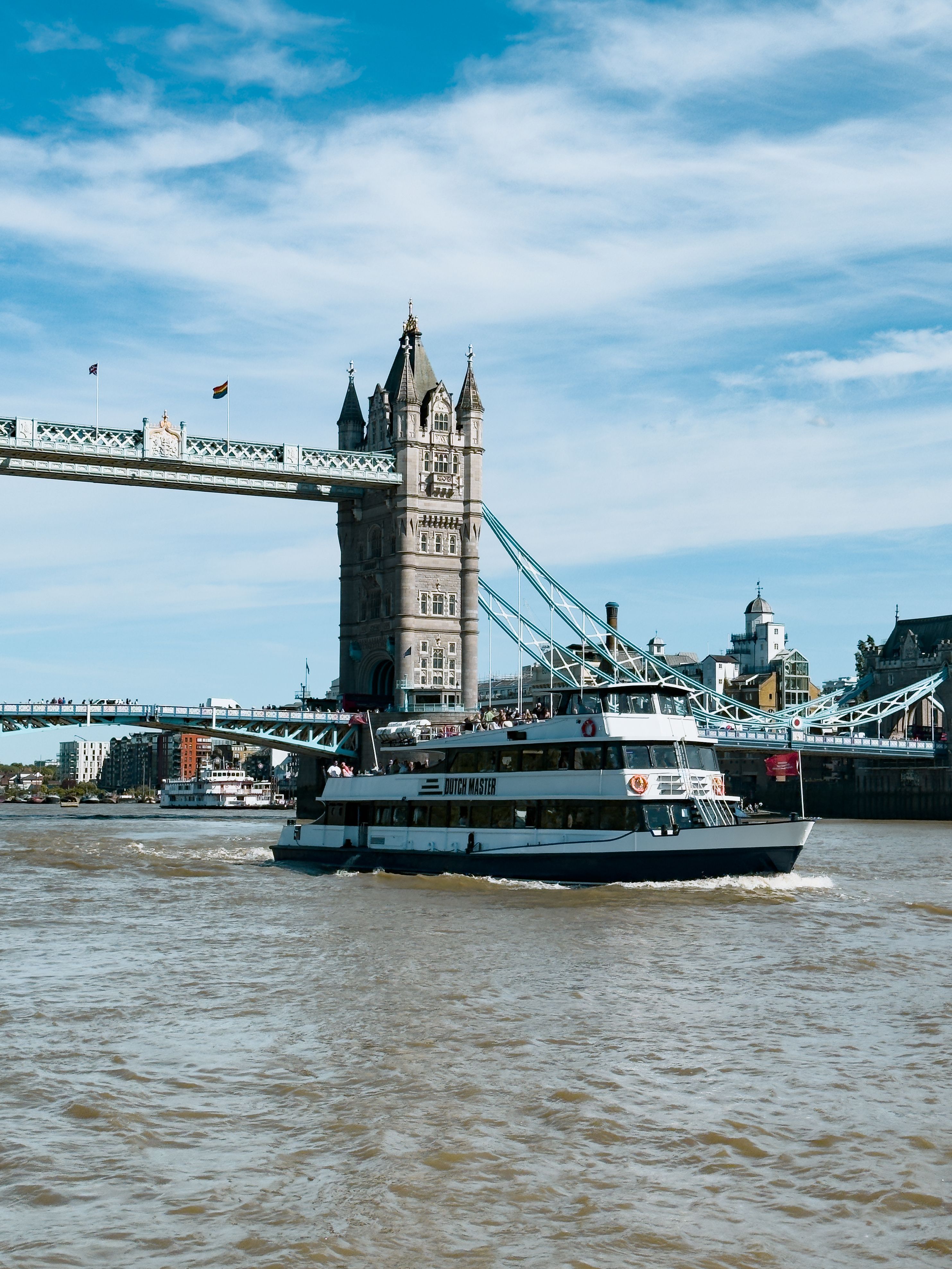 A Thames sightseeing cruise boat passing under Tower Bridge during a London sightseeing tour on the river