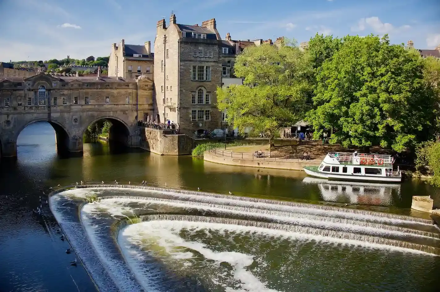 Pulteney Bridge and its weir over the River Avon in Bath, a short walk from the Roman Baths