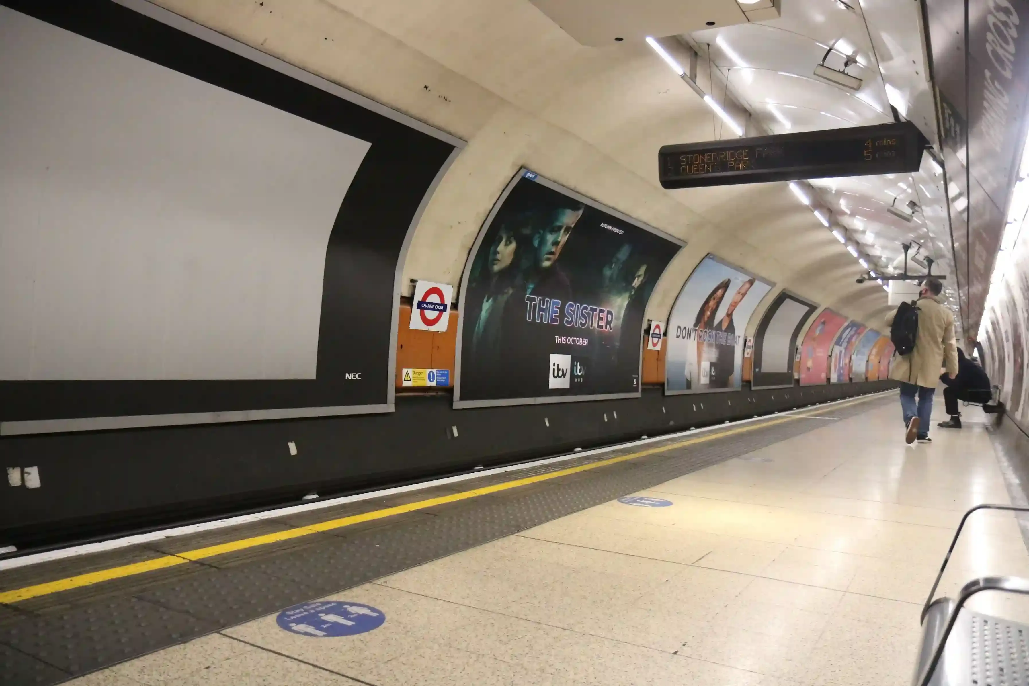 Escalators and signage at the Charing Cross Underground concourse linking the Tube platforms to the mainline station