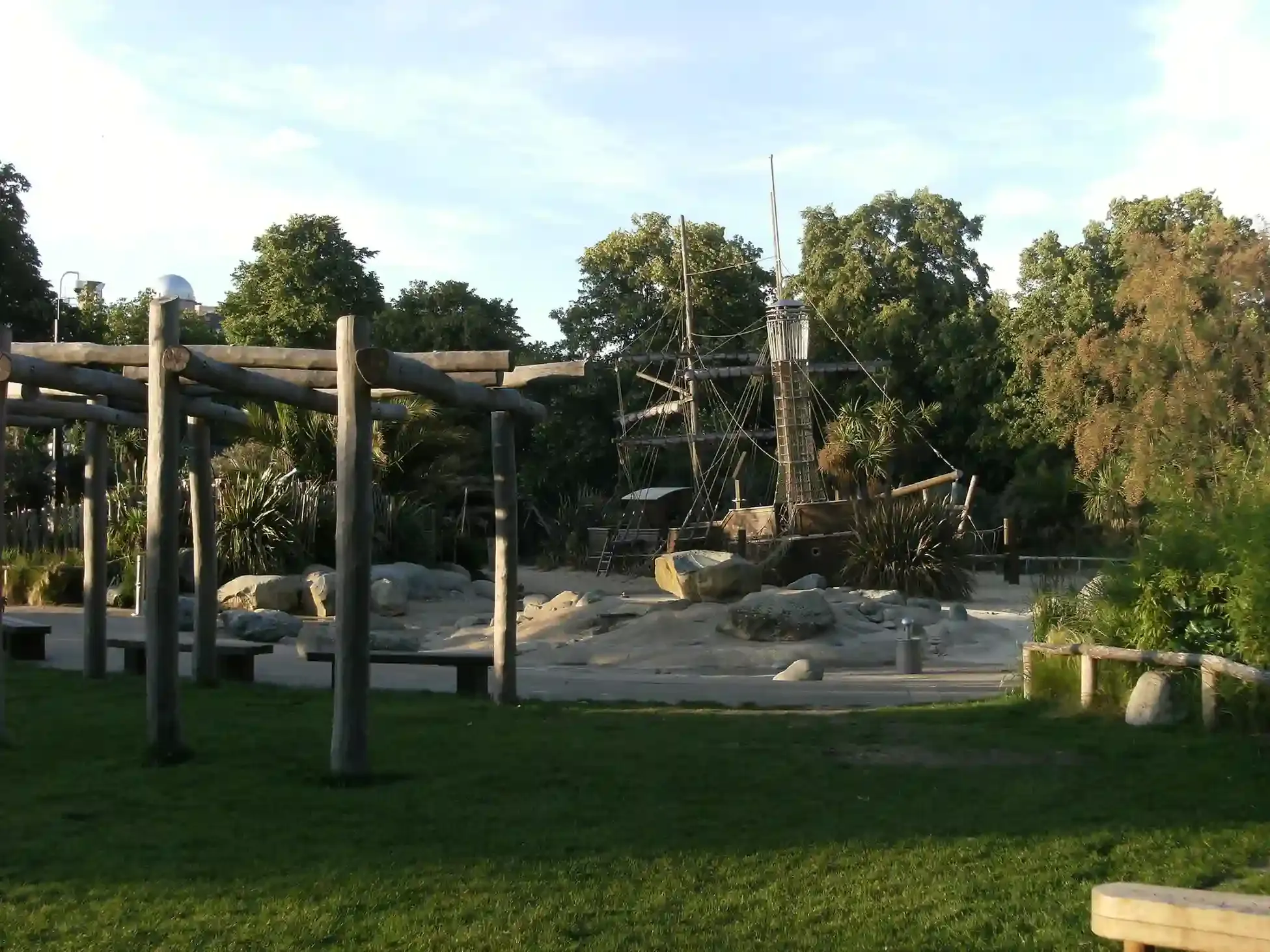 Children climbing the wooden pirate ship at the Diana Memorial Playground in Kensington Gardens in London