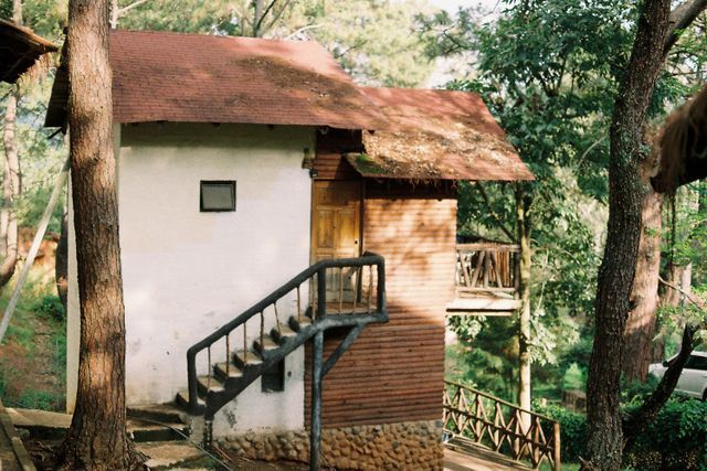 Wooden tree-house cottage surrounded by forest at Tanshikar Spice Farm in Netravali, South Goa